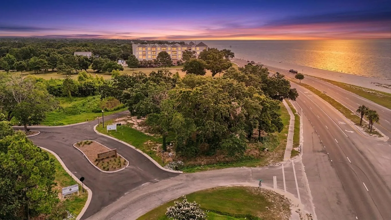 Sunset aerial over Tidewood with the Mississippi Sound and Pass Christian beach at golden hour